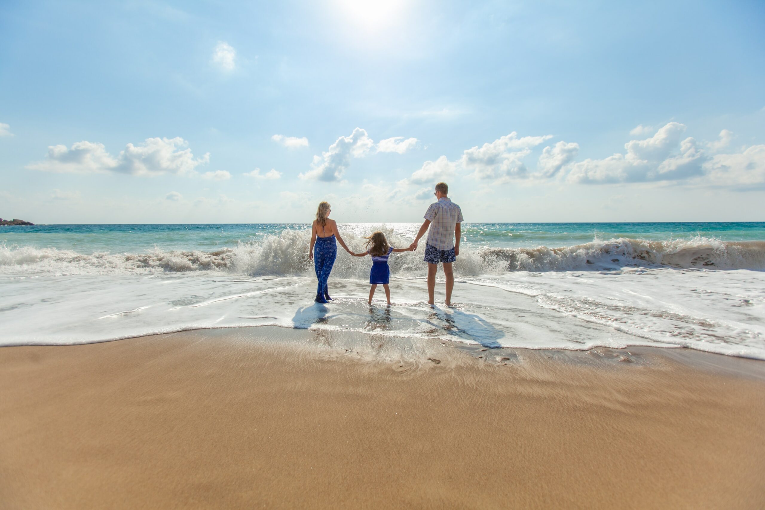 A family of three stood on the beach